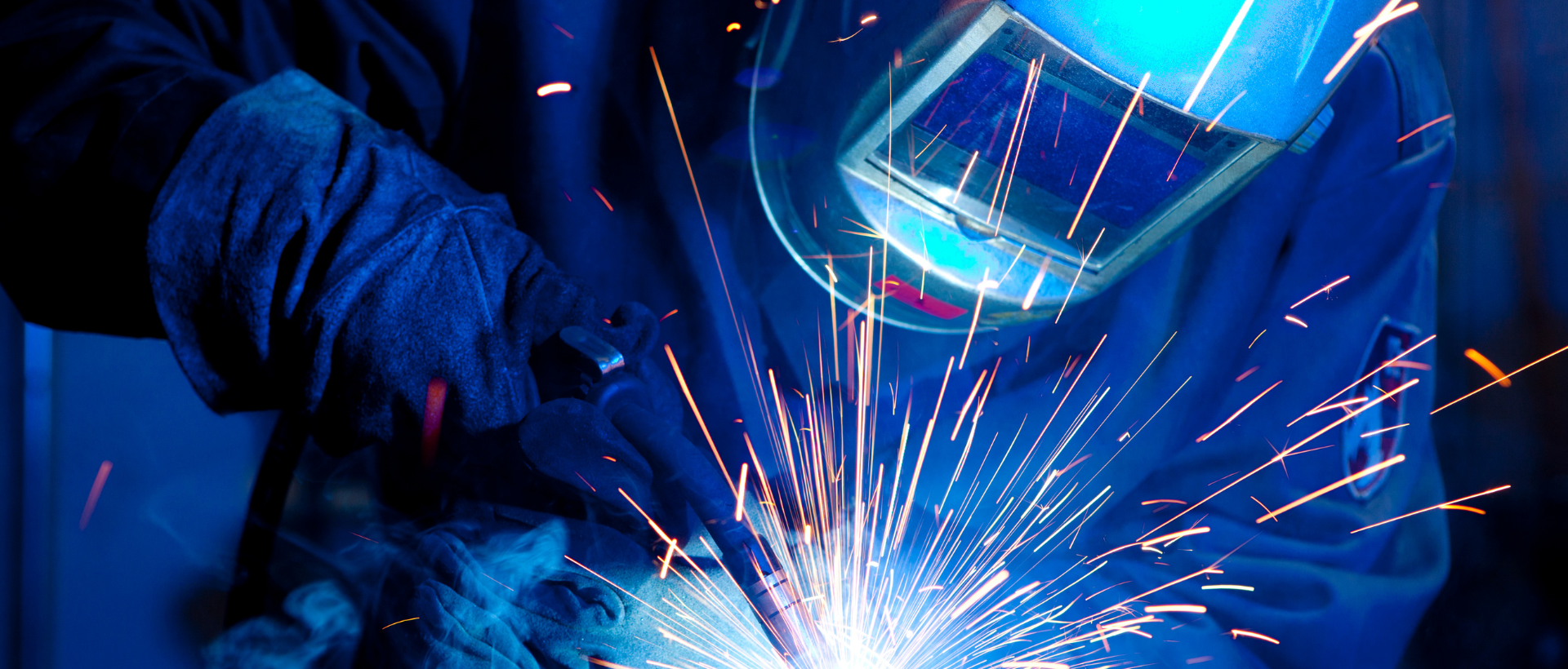 Welder Using Protective Gear While Welding